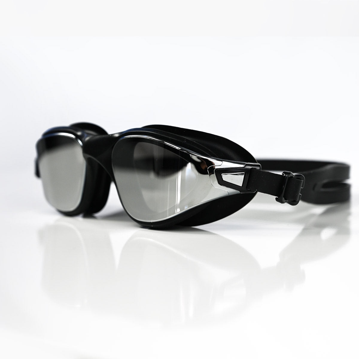 Black Max swim goggles with a reflective silver mirror lens, shown on a clean white reflective surface.