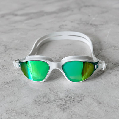 POD AquaLuxe white swim goggles with green mirror lenses photographed front-on on a marble surface