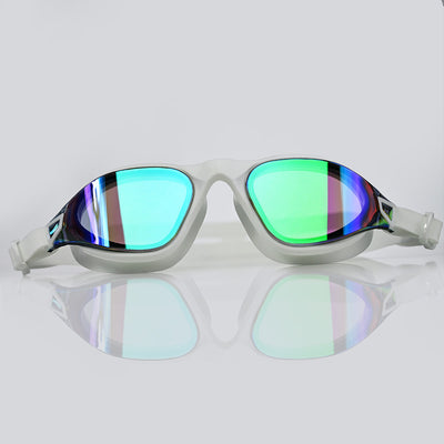 A pair of modern AquaLuxe POD swimming goggles with a translucent light white frame and vibrant mirrored lenses reflecting shades of green, blue, and purple, set against a clean light gray background with a soft reflection below.