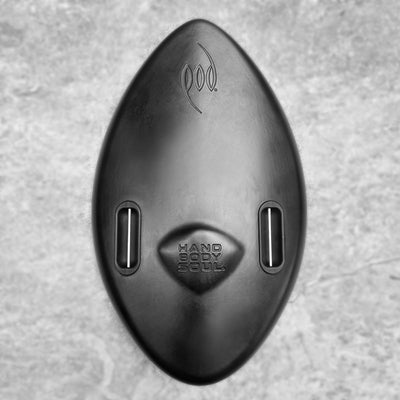 A matte black WOW POD Handboard Bodysurfing Handplane Hand Body Soul with a textured grey stone background.