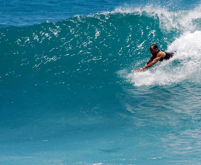 Bodysurfing Technique - Trimming Across the Wave Face Bodysurfer trimming across the wave face in the one-arm push-up position with a POD handboard