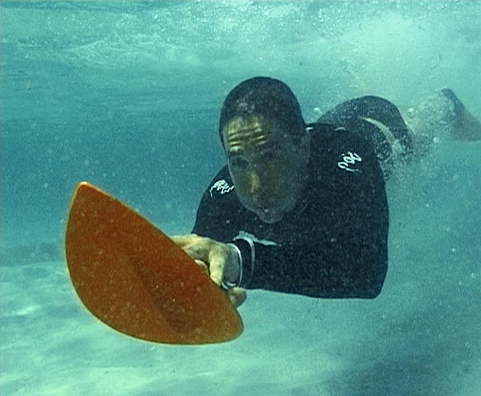 Both hands on a POD handboard when duck diving under the wave